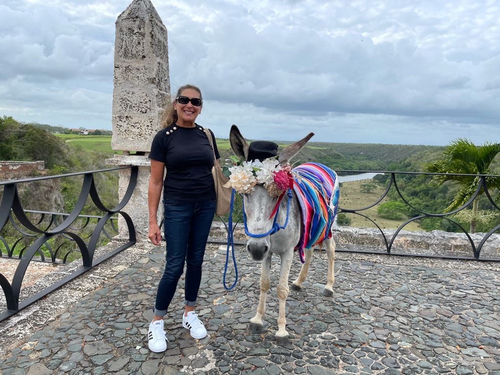 Harrise standing beside a donkey decorated with flowers